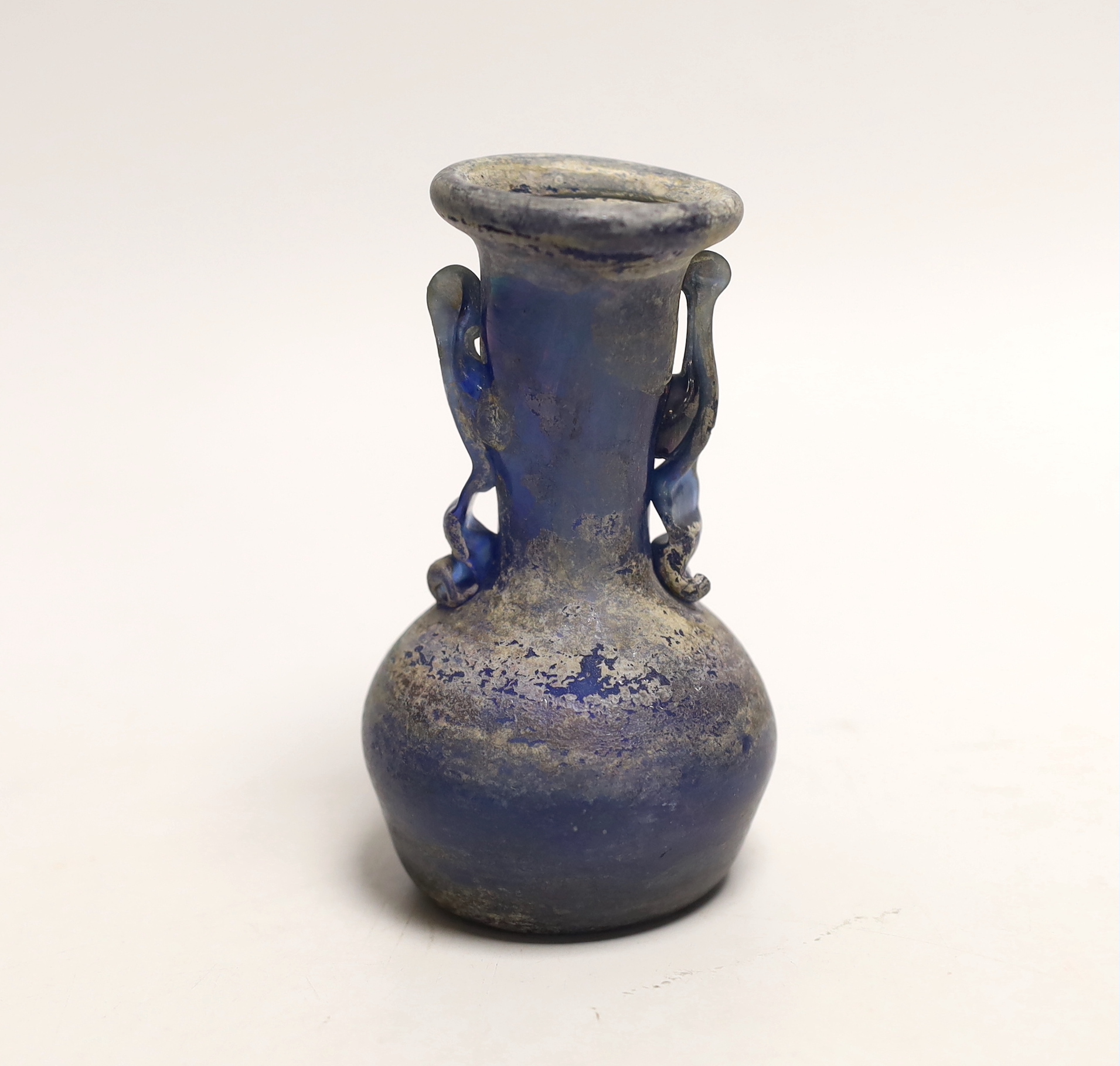 An 8th/9th century Islamic blue glass vase, 12cm